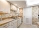 Galley kitchen with stainless steel sink and dishwasher at 1513 Ocean Shore Blvd # 3C, Ormond Beach, FL 32176