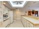 Full kitchen with white cabinets and tiled backsplash at 1513 Ocean Shore Blvd # 3C, Ormond Beach, FL 32176