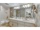 Bathroom with double vanity, large mirror and bathtub at 1513 Ocean Shore Blvd # 3C, Ormond Beach, FL 32176