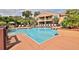 Community pool with surrounding patio and lounge chairs at 1401 S Palmetto Ave # 402, Daytona Beach, FL 32114