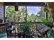 Relaxing screened porch with seating, plants, and tranquil outdoor views at 1401 S Palmetto Ave # 402, Daytona Beach, FL 32114