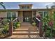 Community center entrance with steps and lush landscaping at 1401 S Palmetto Ave # 402, Daytona Beach, FL 32114