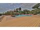Large community pool with expansive deck and surrounding lounge chairs at 1401 S Palmetto Ave # 402, Daytona Beach, FL 32114