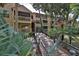 Condo building with walkway, tropical landscaping, and access to building at 1401 S Palmetto Ave # 402, Daytona Beach, FL 32114