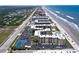 Aerial view of oceanfront condos, pool, tennis court, and parking at 4175 S Atlantic Ave # 1130, New Smyrna Beach, FL 32169