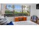 Bedroom with ocean view, wooden desk, and blue striped chair at 4175 S Atlantic Ave # 1130, New Smyrna Beach, FL 32169