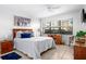 Spacious main bedroom with a comfortable bed and access to balcony at 4175 S Atlantic Ave # 1130, New Smyrna Beach, FL 32169
