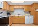Functional kitchen with wood cabinets, providing essential cooking space at 4175 S Atlantic Ave # 1130, New Smyrna Beach, FL 32169