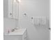 Small bathroom with white vanity, medicine cabinet, and shower at 4175 S Atlantic Ave # 1130, New Smyrna Beach, FL 32169