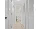 Clean hallway with tile floor, linen closet, and bathroom access at 4175 S Atlantic Ave # 1130, New Smyrna Beach, FL 32169