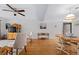 Bright living room with hardwood floors, comfortable seating, and access to the dining area at 4175 S Atlantic Ave # 1130, New Smyrna Beach, FL 32169