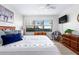 Bright bedroom with a king-size bed, dresser, and beautiful garden view at 4175 S Atlantic Ave # 1130, New Smyrna Beach, FL 32169