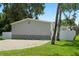 Exterior view showing the home's gray siding and paved driveway at 1164 Bayview Ln, Port Orange, FL 32127