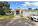 Two-story house with attached two-car garage, circular driveway, and lush landscaping at 200 John Anderson Dr, Ormond Beach, FL 32176