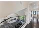 Upper hallway with glass railing overlooking living room at 200 John Anderson Dr, Ormond Beach, FL 32176