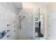 Large walk-in shower with multiple shower heads and marble tile at 200 John Anderson Dr, Ormond Beach, FL 32176