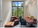 Home office features a large window, leather chairs, and antique desk at 200 John Anderson Dr, Ormond Beach, FL 32176