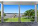 Covered patio overlooking a tranquil waterfront scene with private dock at 200 John Anderson Dr, Ormond Beach, FL 32176