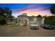 Luxury home exterior at dusk featuring a two-car garage and landscaping at 200 John Anderson Dr, Ormond Beach, FL 32176
