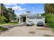 Two-story house with attached two-car garage, circular driveway, and lush landscaping at 200 John Anderson Dr, Ormond Beach, FL 32176