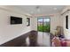 Bedroom with water view, dark hardwood floors and sliding glass doors at 200 John Anderson Dr, Ormond Beach, FL 32176