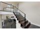 Modern glass and dark wood staircase overlooking living area at 200 John Anderson Dr, Ormond Beach, FL 32176