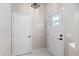 Bright entryway with white walls, a coat rack and door to the interior at 1117 Athlone Way, Ormond Beach, FL 32174
