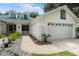 Exterior view of a single story house with a two car garage and landscaped walkway at 1117 Athlone Way, Ormond Beach, FL 32174