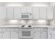 Modern kitchen with white cabinets, a microwave, and an electric cooktop at 1117 Athlone Way, Ormond Beach, FL 32174
