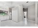 Kitchen with white cabinets, tile floor and a view into the living room at 1117 Athlone Way, Ormond Beach, FL 32174