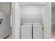 White laundry closet with washer and dryer in a light and bright space at 1117 Athlone Way, Ormond Beach, FL 32174