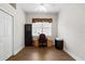 Home office with wood-look floors, built-in shelving, and a large window at 1117 Athlone Way, Ormond Beach, FL 32174