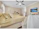 Main bedroom with a king bed, stylish decor, and a ceiling fan at 450 W Delaware Ave, Lake Helen, FL 32744