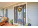 Inviting front door with a decorative wreath and sidelights at 450 W Delaware Ave, Lake Helen, FL 32744