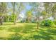 Spacious backyard with lush landscaping and trees at 450 W Delaware Ave, Lake Helen, FL 32744
