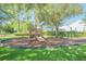 Community playground with playset and wood chips at 450 W Delaware Ave, Lake Helen, FL 32744