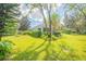 Lush green backyard with mature trees and landscaping at 450 W Delaware Ave, Lake Helen, FL 32744