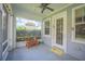 Cozy screened porch with a ceiling fan and outdoor furniture at 450 W Delaware Ave, Lake Helen, FL 32744