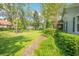 Landscaped side yard with lush greenery and a walkway at 450 W Delaware Ave, Lake Helen, FL 32744