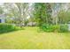 Large backyard with lush green grass and mature trees at 450 W Delaware Ave, Lake Helen, FL 32744