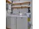 Laundry room with washer, dryer, and shelving at 13 Villa Villar # 0, Deland, FL 32724