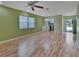 Living room with laminate flooring, green walls, and access to kitchen at 13 Villa Villar # 0, Deland, FL 32724