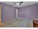 Bright bedroom with ceiling fan and door to bathroom at 13 Villa Villar # 0, Deland, FL 32724