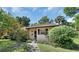 House exterior featuring a walkway, lush landscaping, and a charming entrance at 13 Villa Villar # 0, Deland, FL 32724