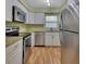 Kitchen with stainless steel appliances and white cabinets at 13 Villa Villar # 0, Deland, FL 32724