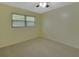 Simple bedroom with ceiling fan and window at 13 Villa Villar # 0, Deland, FL 32724