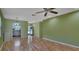 Open living area with hardwood floors and a view of the kitchen at 13 Villa Villar # 0, Deland, FL 32724