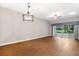 Living room with wood floors and sliding glass doors at 1117 Athlone Way, Ormond Beach, FL 32174
