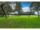 Lush green golf course with mature oak trees at 1117 Athlone Way, Ormond Beach, FL 32174