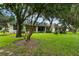 Home's backyard with a screened patio and golf course view at 1117 Athlone Way, Ormond Beach, FL 32174